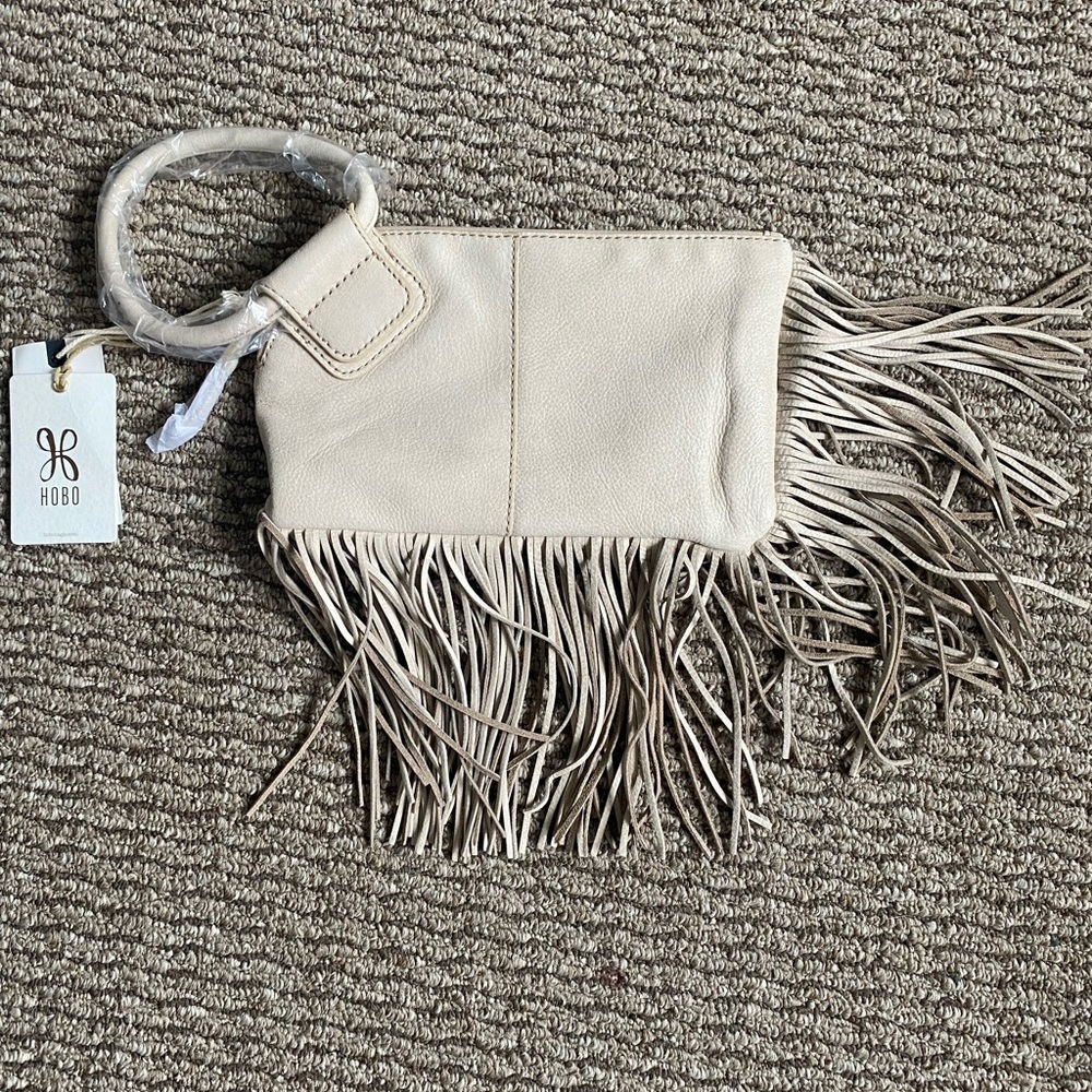 Hobo purse. Wristlet. White color with fringe. Leather.